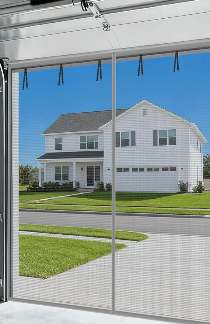 The view out through a FEGO privacy garage door screen: the house across the street is clear