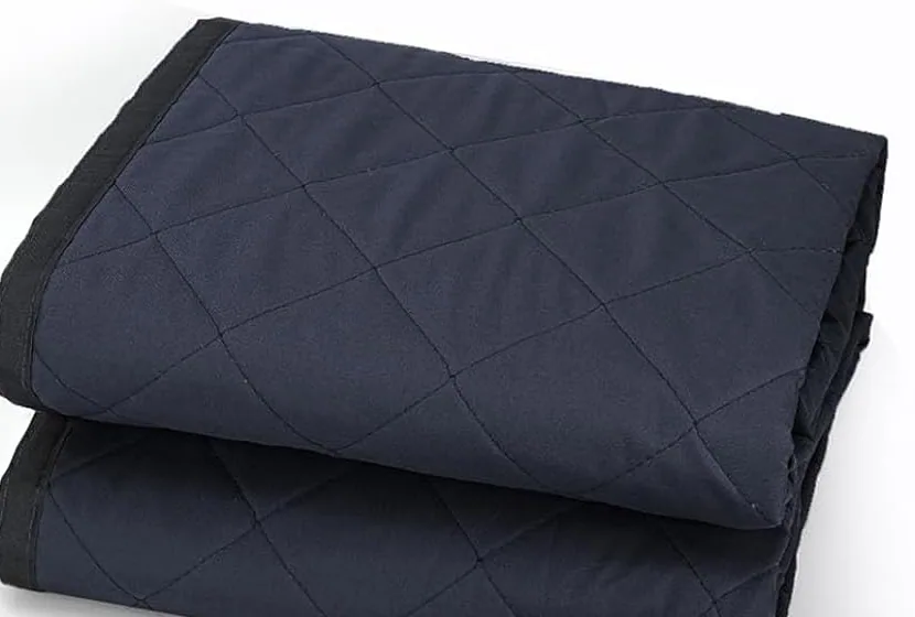 A FEGO winter garage door curtain folded, showing its quilted padded fabric