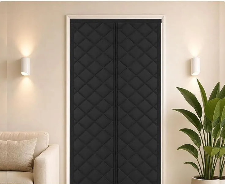 A black FEGO thermal door curtain on a balcony door